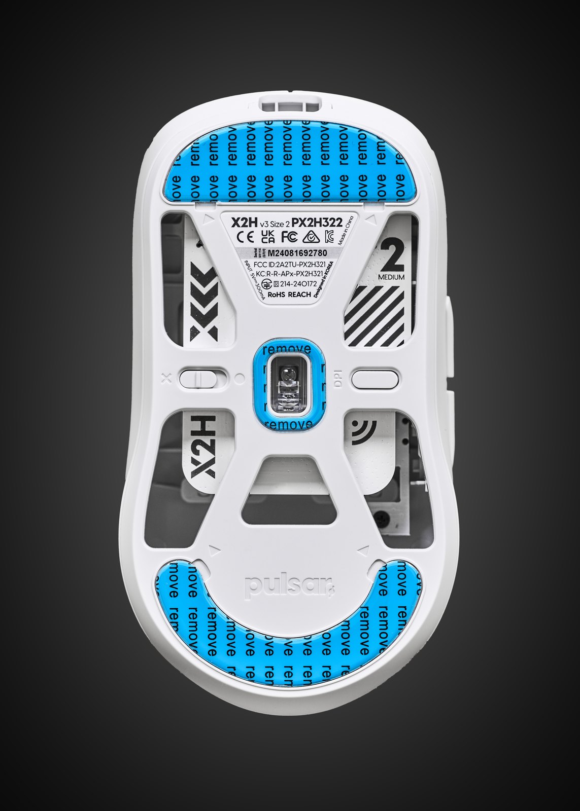 Underside of a gaming mouse showing the sensor aperture
